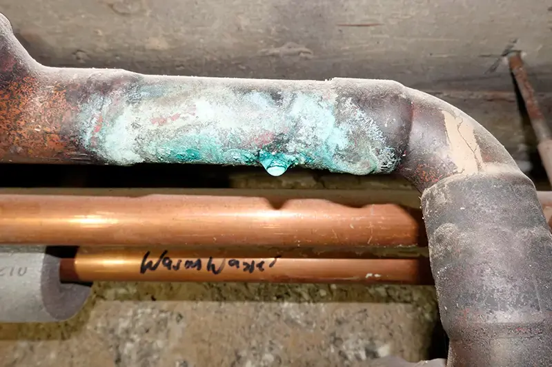 Dripping corroded copper water pipe