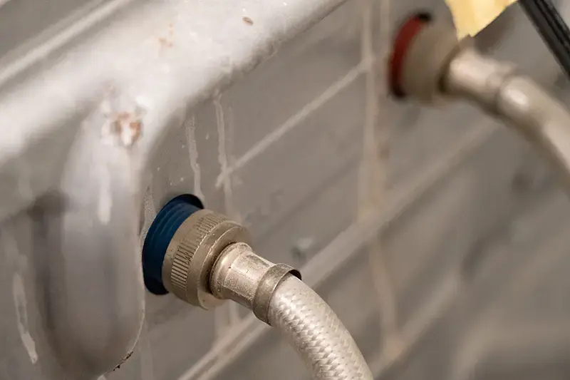 Hoses behind a washing machine