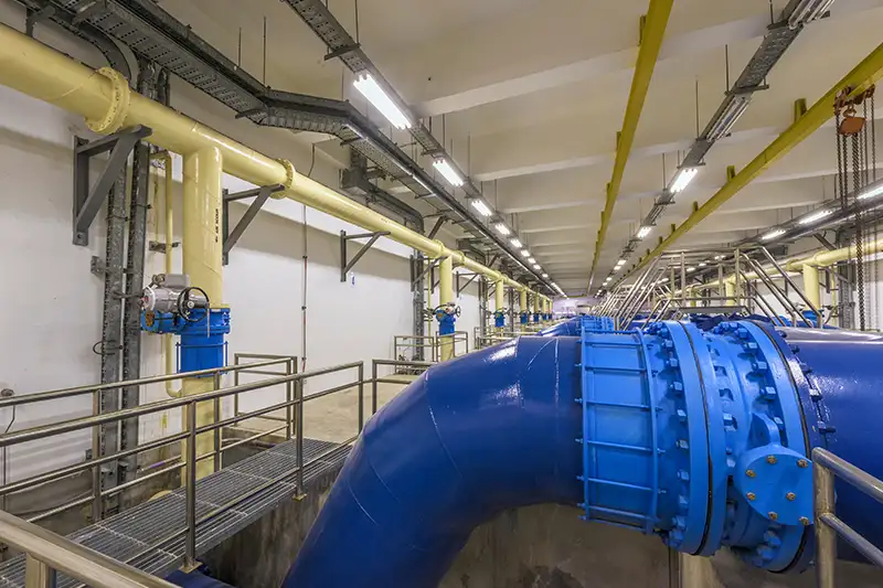 Large blue flanges and pipes in a water processing plant